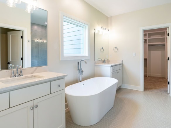 Bathroom with a sleek freestanding bathtub and double vanity.