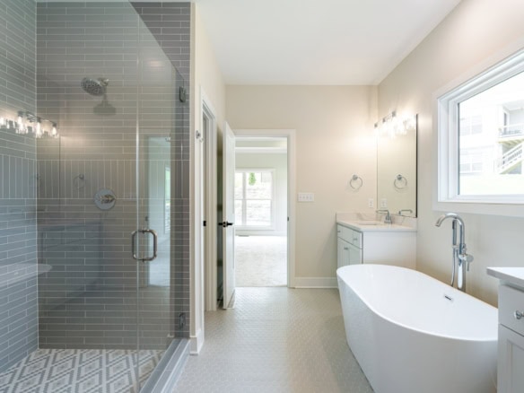 Modern bathroom featuring a walk-in shower and freestanding tub at 6209 Brentwood Dr.