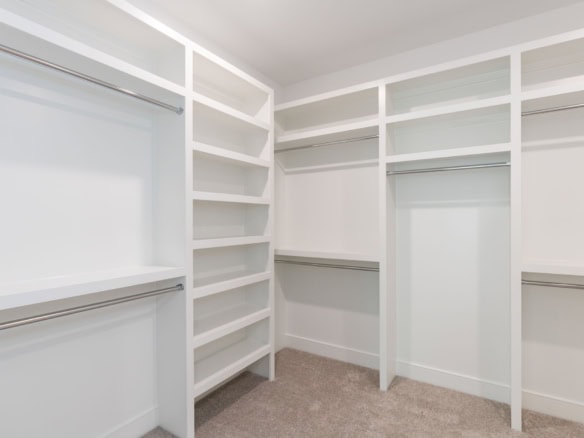 Custom walk-in closet with ample shelving and hanging space for organized storage.