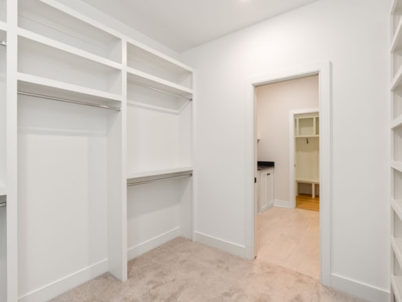 Bright walk-in closet with custom shelving and ample storage space.