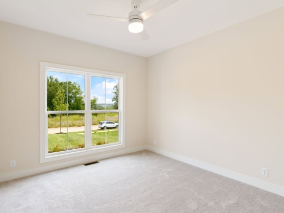 Interior view of a bright, empty room with large window at 6209 Brentwood Dr.