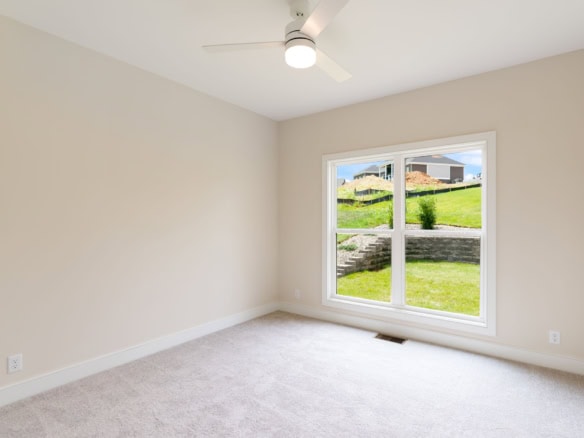 Interior room featuring a spacious layout and a large window overlooking a green yard.