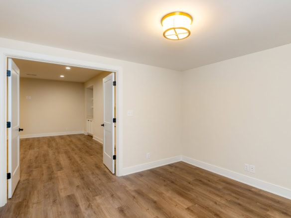 Renovated interior room with neutral walls and wood flooring at 6209 Brentwood Dr.