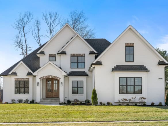 Beautiful white house with black roof and multiple gables, located at 6286 Clore Lane.