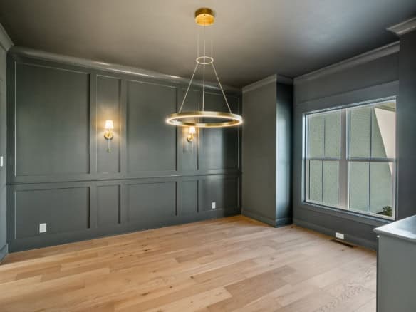 Modern interior living room with dark gray walls and large window.