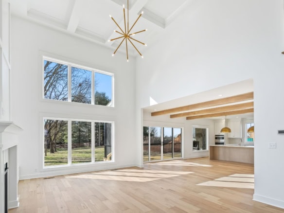 Interior view of a spacious, bright living area at 6286 Clore Lane, showcasing high ceilings and lar.