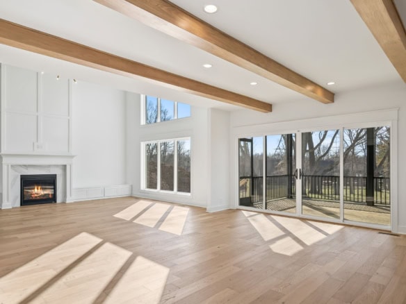 Spacious living area featuring high ceilings, large windows, and natural light.