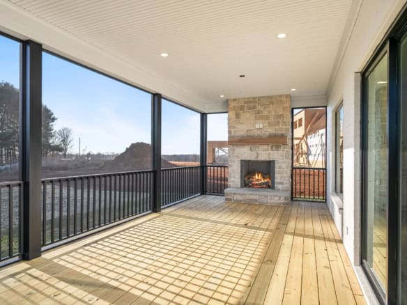 Screened porch with fireplace at 6286 Clore Lane, showcasing a spacious outdoor living area.