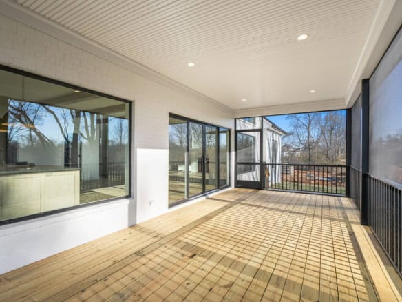 Screened porch with large windows and wooden flooring at 6286 Clore Lane.