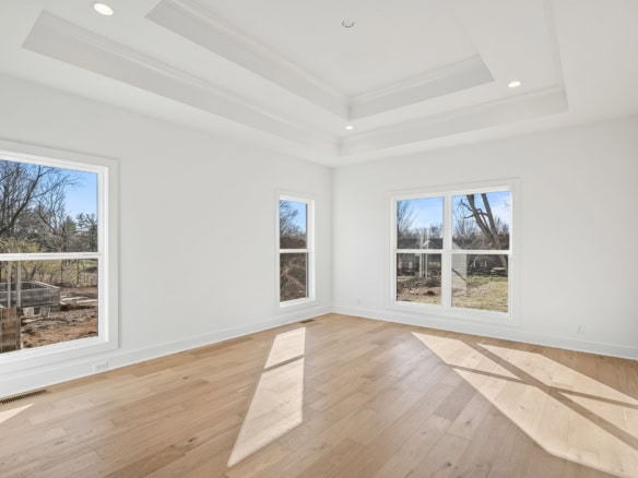 Interior of a bright, spacious living room at 6286 Clore Lane, featuring large windows and hardwood.