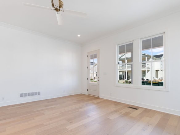 Bright, spacious living room with large windows and white walls.