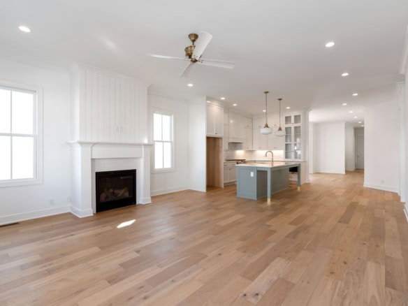 Spacious living room with hardwood floors and natural light.