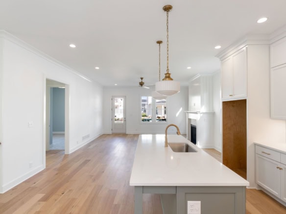 Bright kitchen featuring white cabinetry, a central island, and natural light.