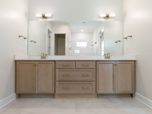 Elegant bathroom vanity with dual sinks and large mirror.