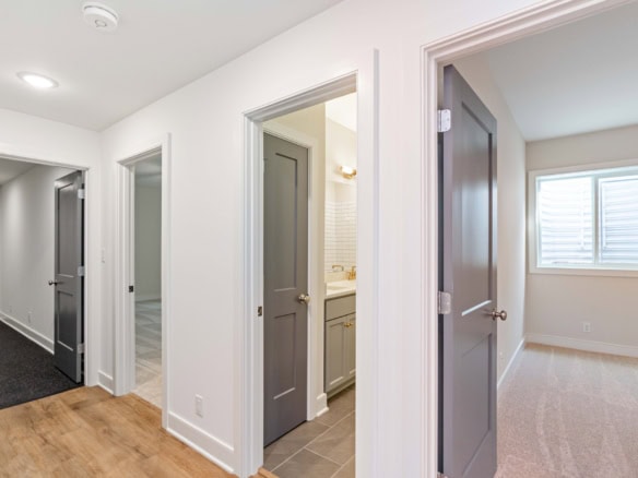 Bright interior hallway with multiple doors and windows.