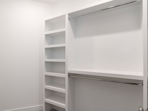 Closet organization with shelves and hanging space.