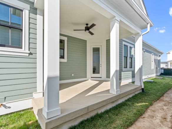 Modern house porch with ceiling fan at 11326 River Beauty Loop.