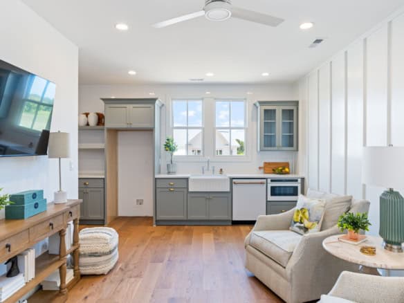 Interior view of a modern, bright kitchen and living room.