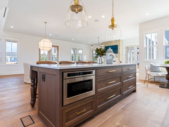 Bright, spacious kitchen with island, large windows, and modern decor.