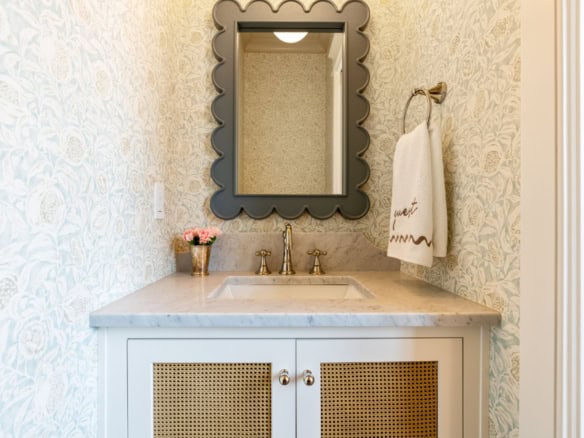 Bathroom vanity with mirror, sink, and towel in a stylish home interior.
