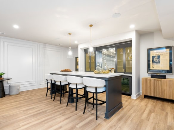 Spacious kitchen featuring a central island, bar stools, and contemporary decor.