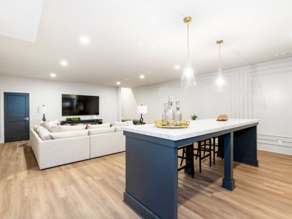 Modern open-concept living room and kitchen with island and seating.