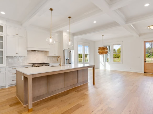 Bright, spacious open-concept kitchen and living room with large windows.