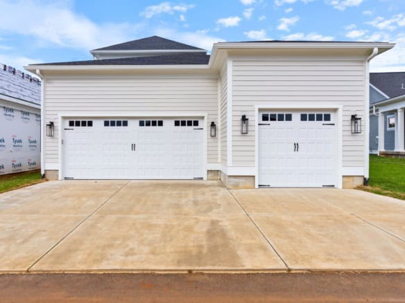 New construction garage with double doors and clean exterior at 11612 Skypilot Street.