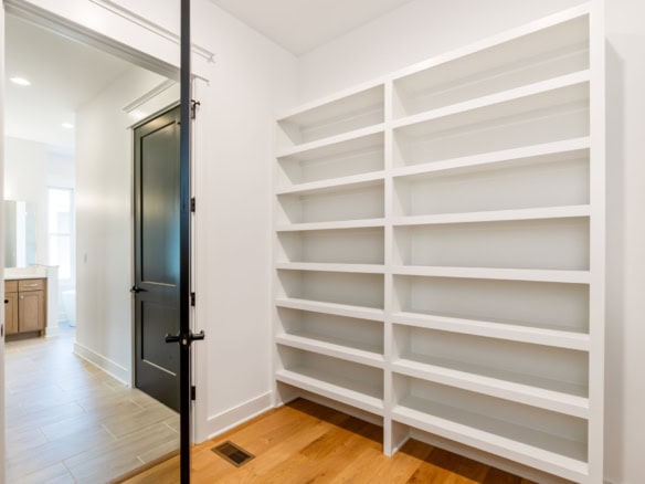 Custom built-in white shelving unit in a modern home.