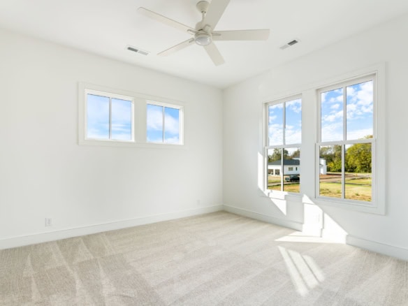 Bright, airy interior room with large windows and white walls at 11612 Skypilot Street.