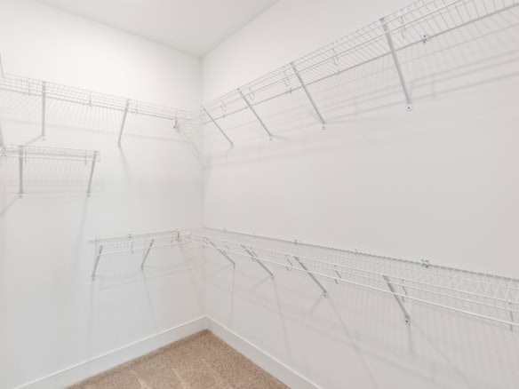 Interior walk-in closet with wire shelving system.
