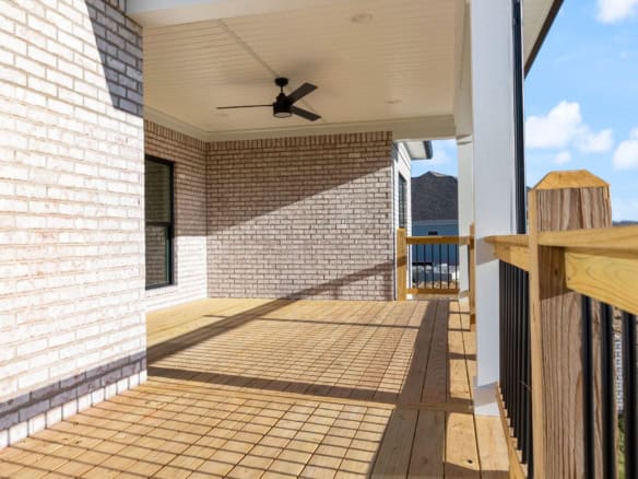 Balcony with wooden flooring and black railing at 3228 Catalpa Farms Drive.