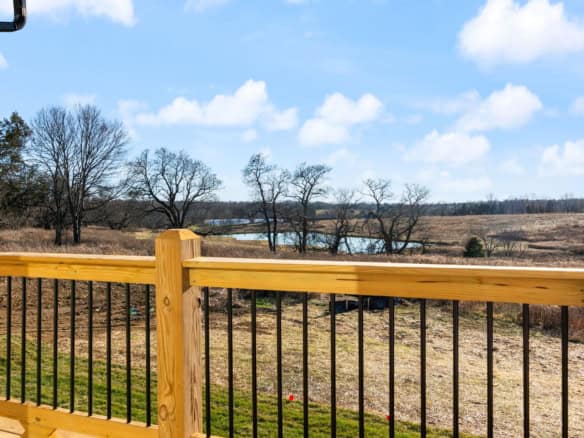 Deck with view of open farmland and trees at 3228 Catalpa Farms Drive.