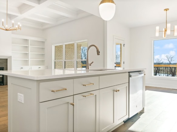 Modern white kitchen with island and large window at 3228 Catalpa Farms Drive.