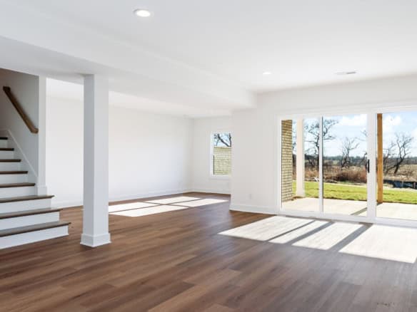 Bright, spacious living room with large windows and hardwood floors at 3228 Catalpa Farms Drive.