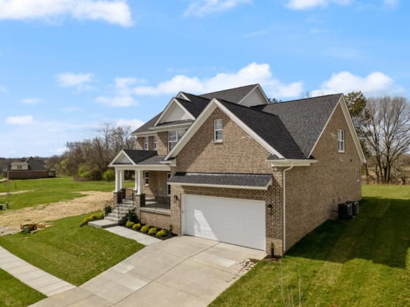 Beautiful brick house with a spacious driveway and well-maintained lawn at 3234 Catalpa Farms Dr.