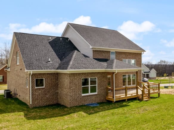 Beautiful brick house with a spacious wooden deck and large windows. Perfect for family living and o.