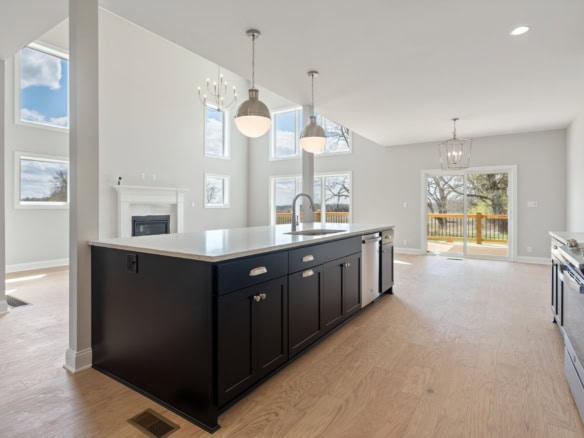 Spacious kitchen featuring a large island, sleek black cabinetry, and ample natural light at 3234 Ca.
