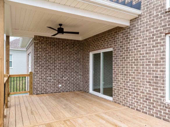 Outdoor brick patio with covered area and ceiling fan at 3234 Catalpa Farms Dr.