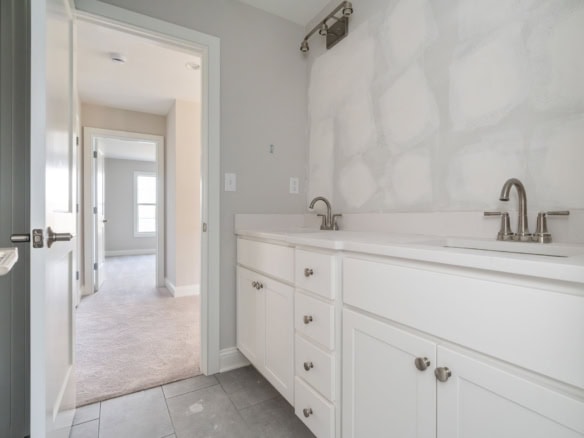 Bathroom vanity with dual sinks and white cabinetry.