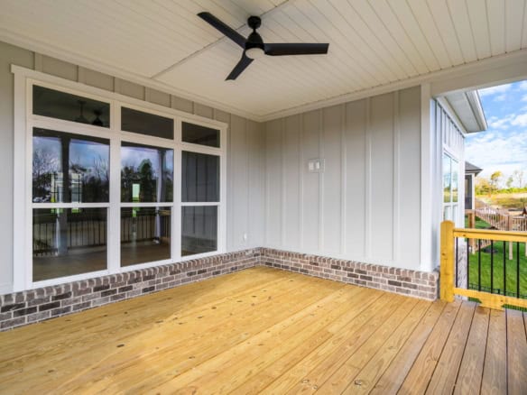 Covered porch with ceiling fan and large windows at 3235 Catalpa Farms Dr.