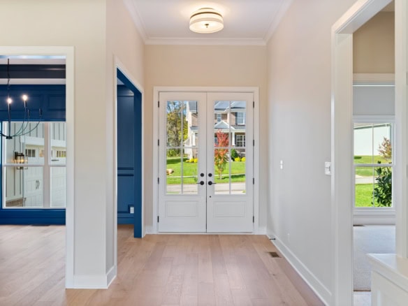 Bright and welcoming front door area with large windows and natural light.