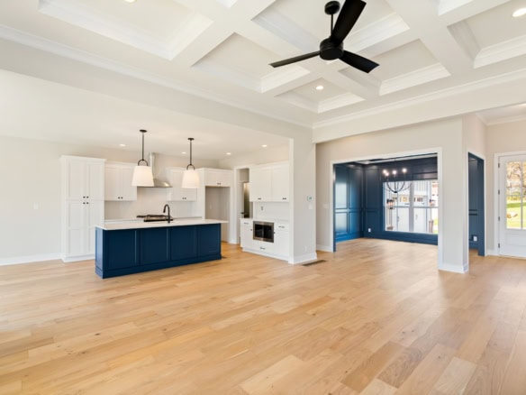 Spacious open-concept kitchen and living room with high ceilings and natural light.