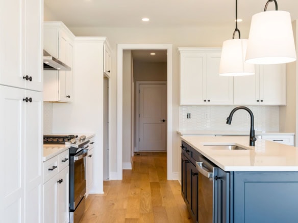 Beautiful modern kitchen with white cabinetry and a central island. Perfect for family cooking and e.