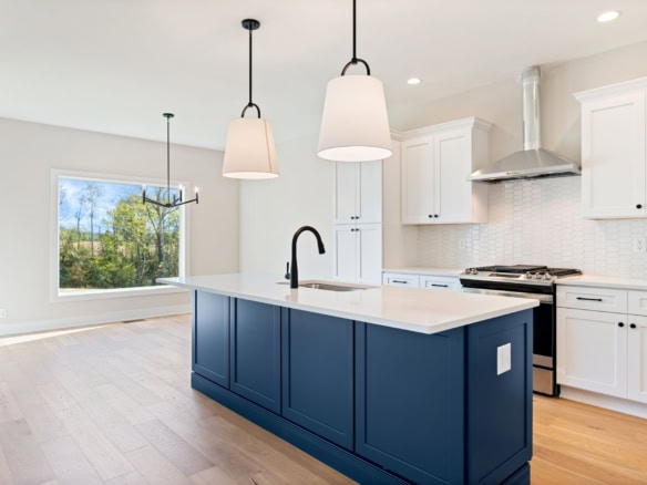 Bright modern kitchen with white cabinets and blue island at 3235 Catalpa Farms Dr.