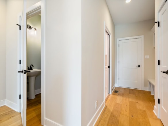 Interior hallway at 3235 Catalpa Farms Dr with hardwood floors and white walls.