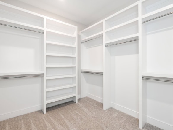 Custom walk-in closet with organized shelving and hanging space.