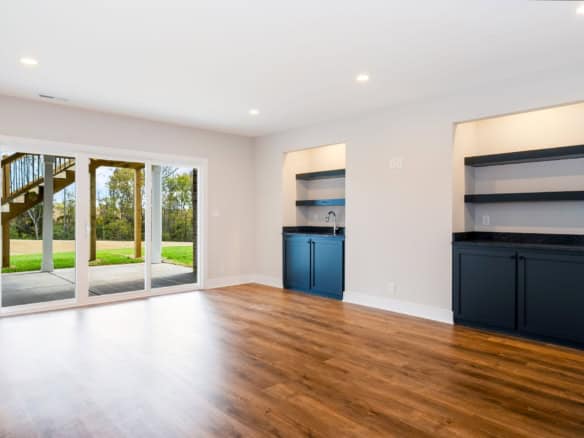 Bright living space with large glass doors and hardwood floors.