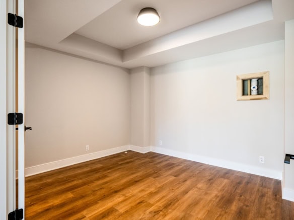 Empty modern room with hardwood floors and white walls at 3235 Catalpa Farms Dr.