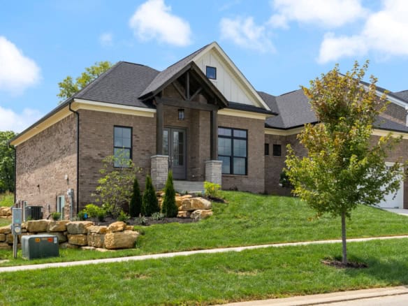 Beautiful new construction home with brick exterior and large front porch.